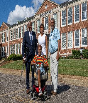 Amani Smith-McDaniel, an incoming Alabama State University freshman, is pictured with university and community representatives after receiving a motorized mobility scooter to assist her in navigating campus.